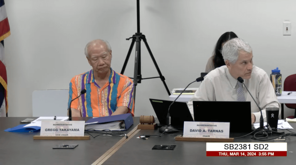 Reps. Gregg Takayama (left) and David Tarnas during a hearing where a bill to create comprehensive public financing of Hawaii elections died. House Speaker Scott Saiki said he personally supports publicly funded elections, but deferred to the wishes of his fellow House members on the issue. (Screenshot/2024)